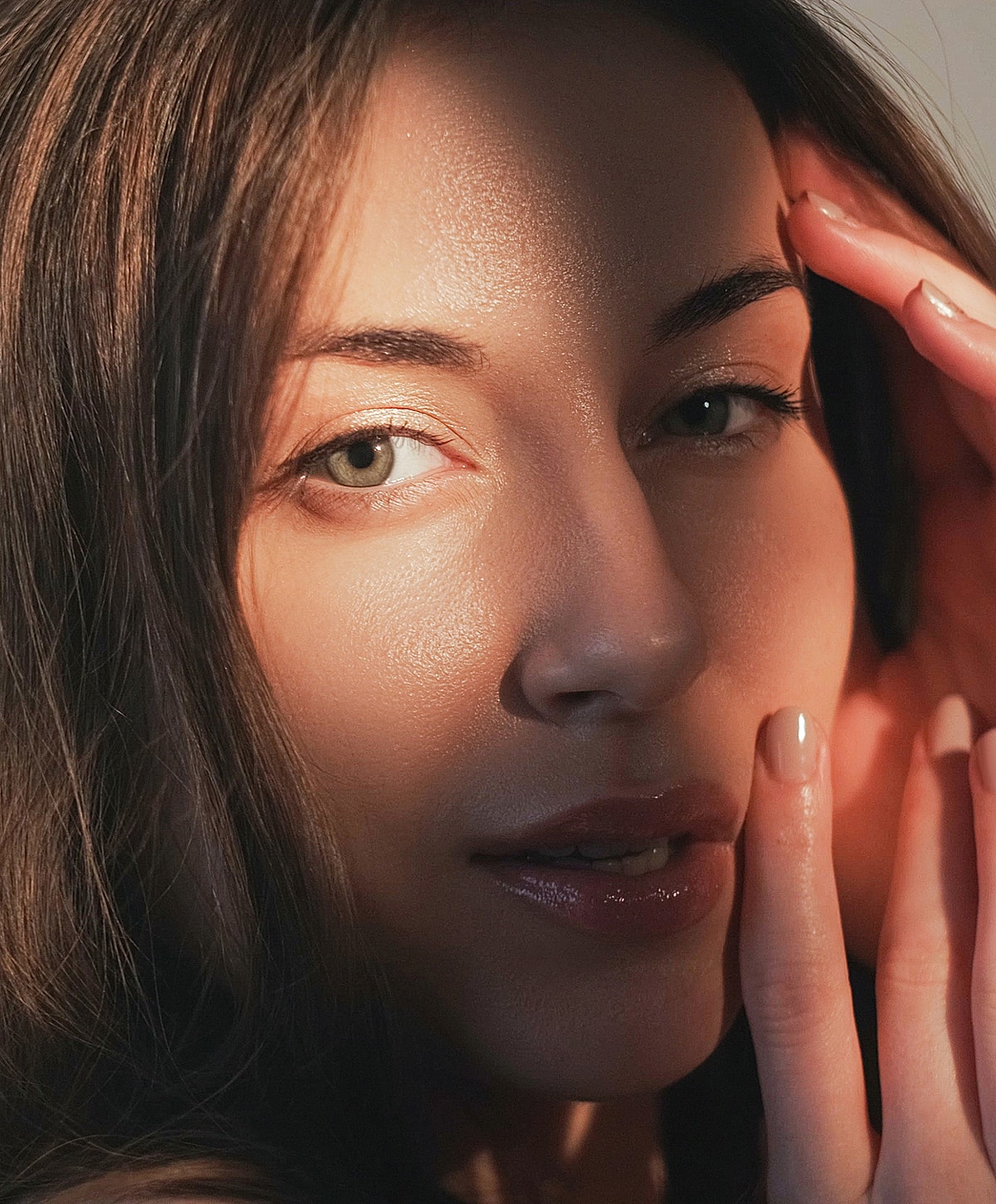 Close-up portrait of a woman in soft light.