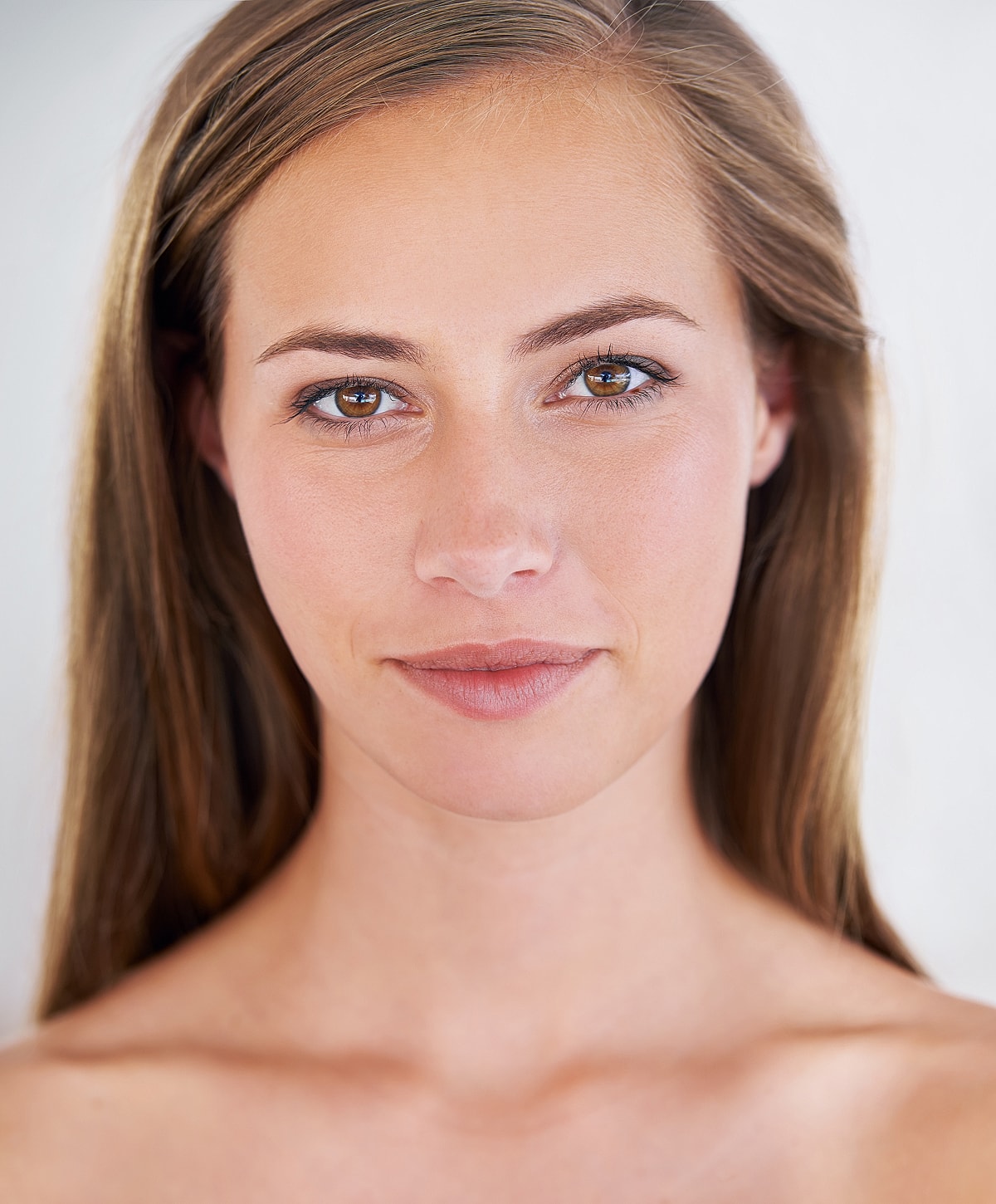 Woman with long hair and natural makeup.