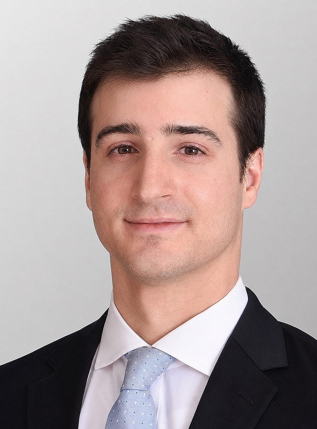 Professional portrait of a young man in suit.
