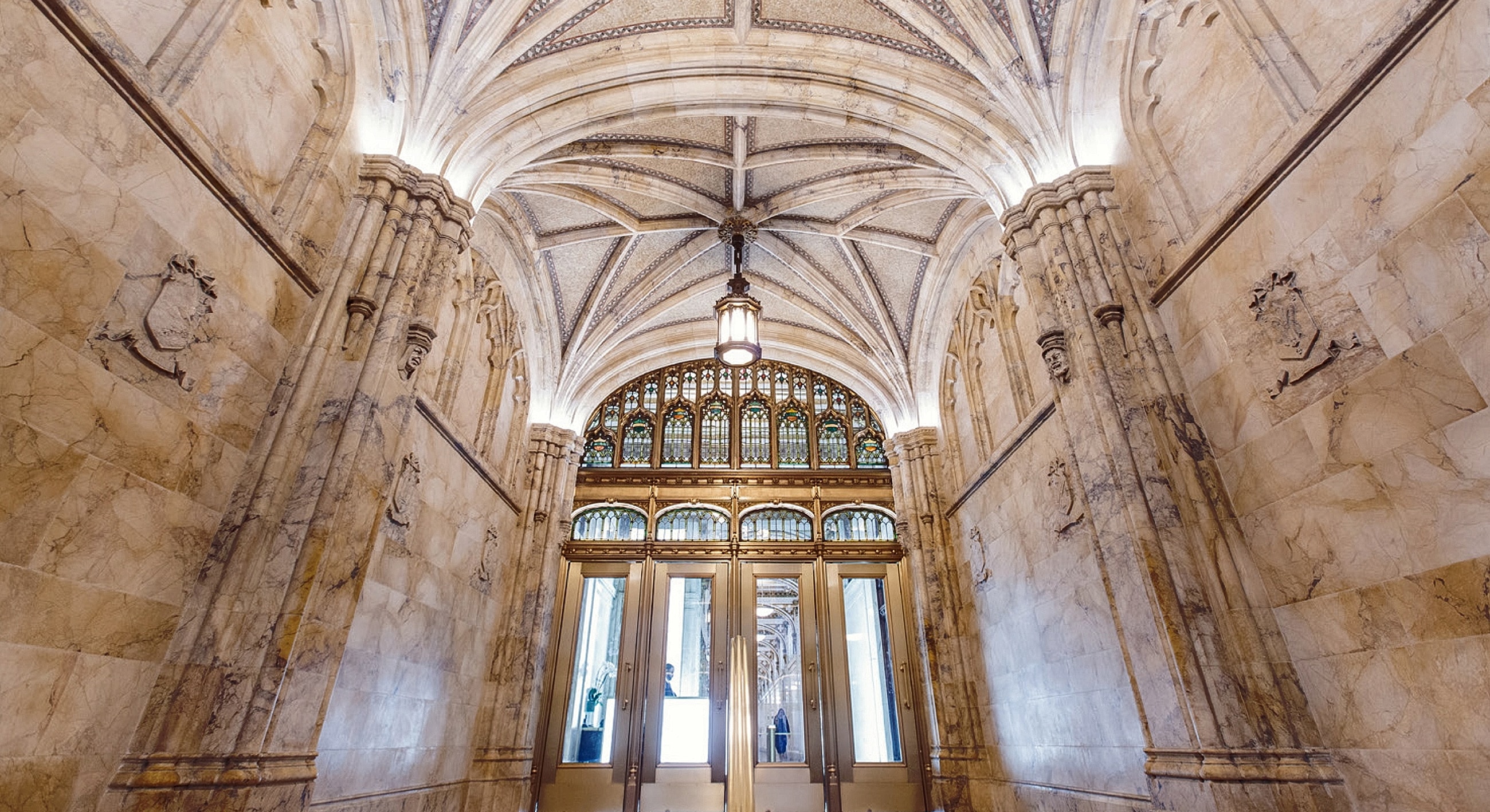 Elegant interior with arched ceiling and stained glass.