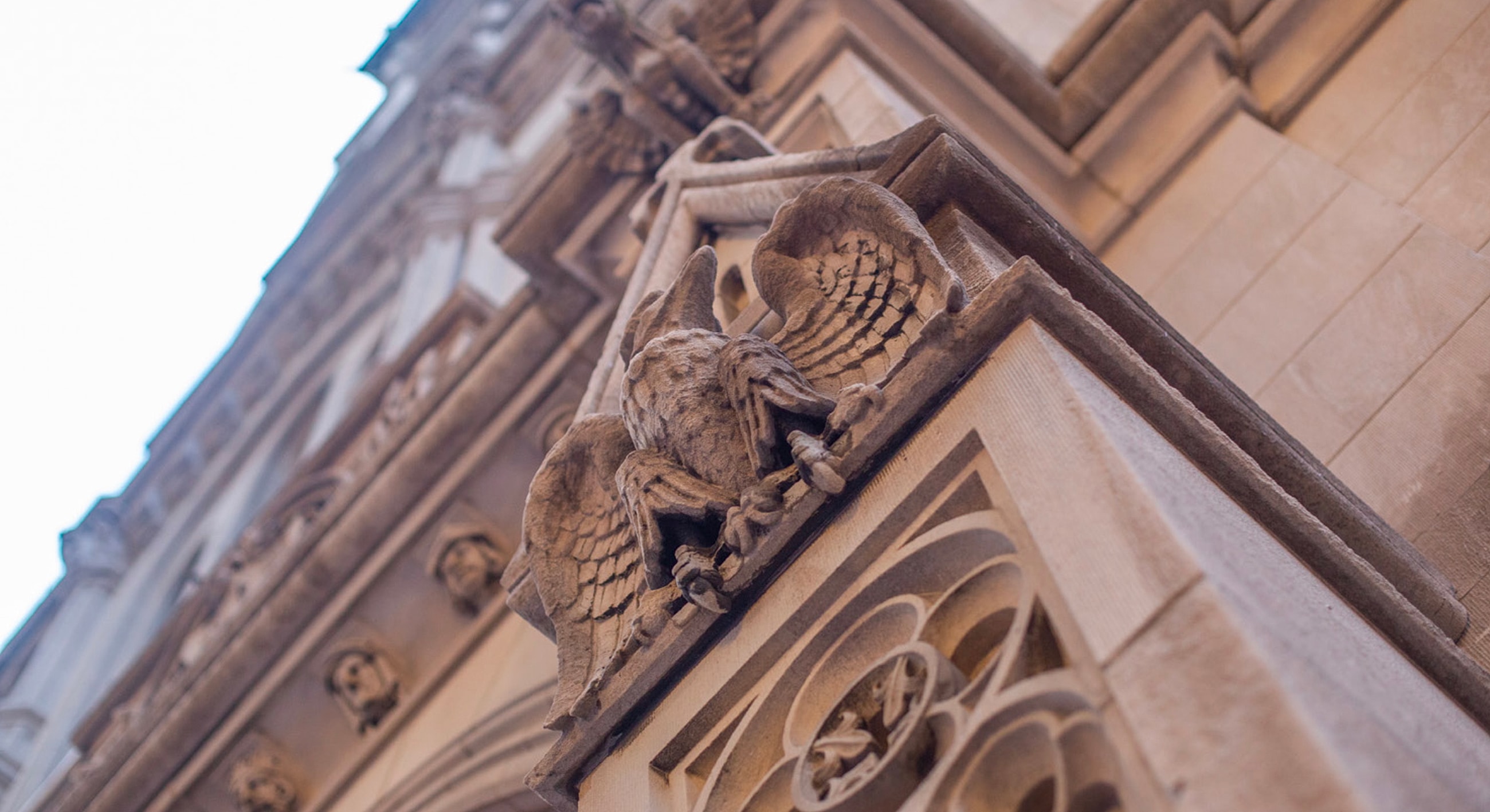 Ornate eagle carvings on building corner.