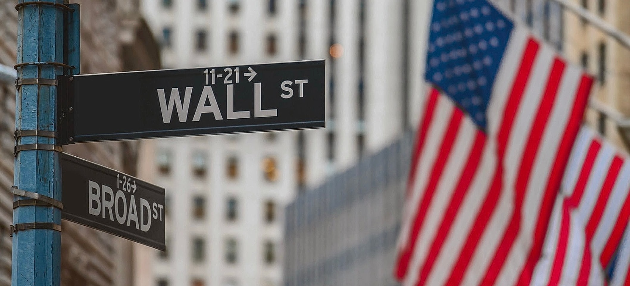 Wall Street and Broad Street intersection with flags.